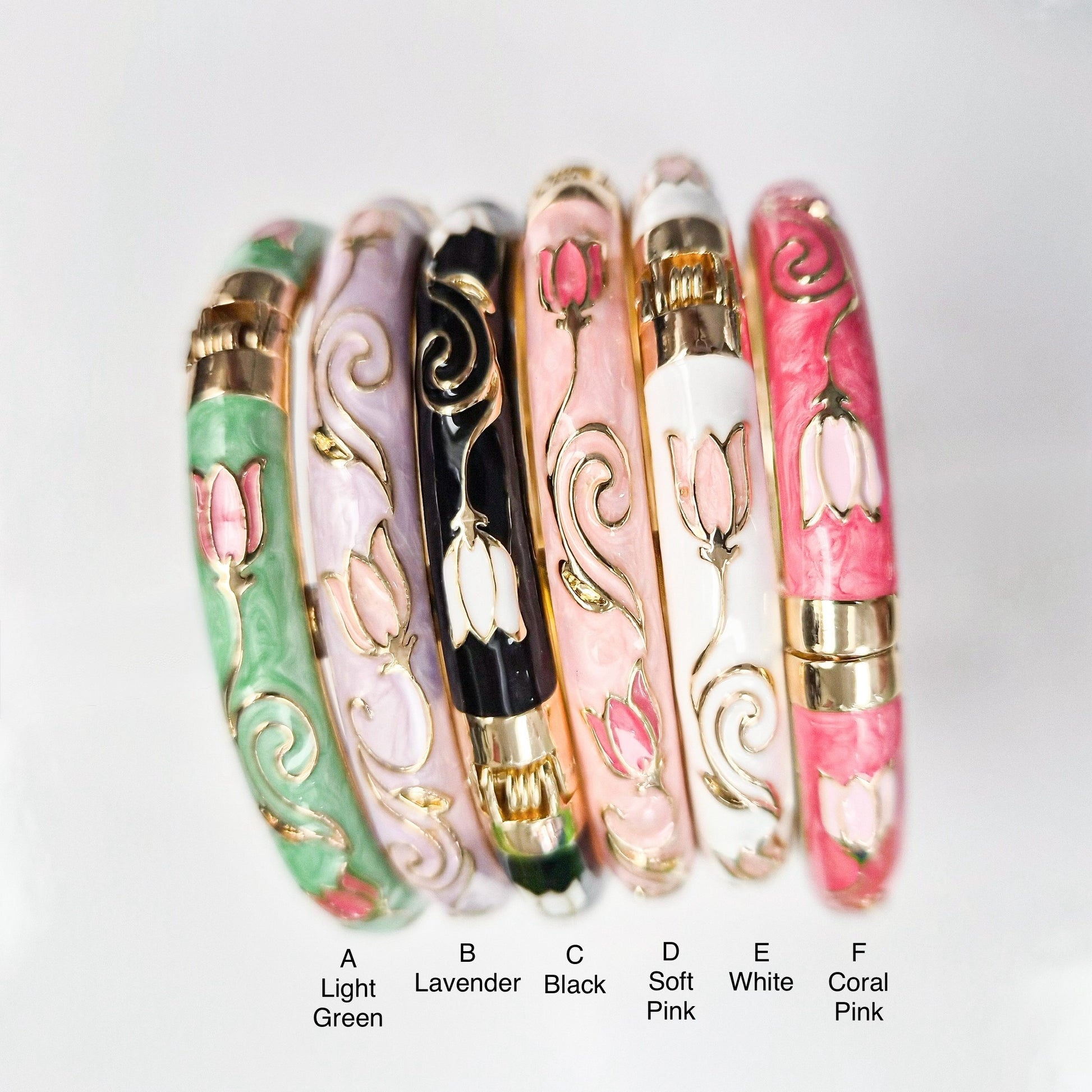 Set of six floral-patterned bangles in various colors on a white background
