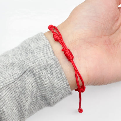 red string bracelet with sliding knot modeled on wrist