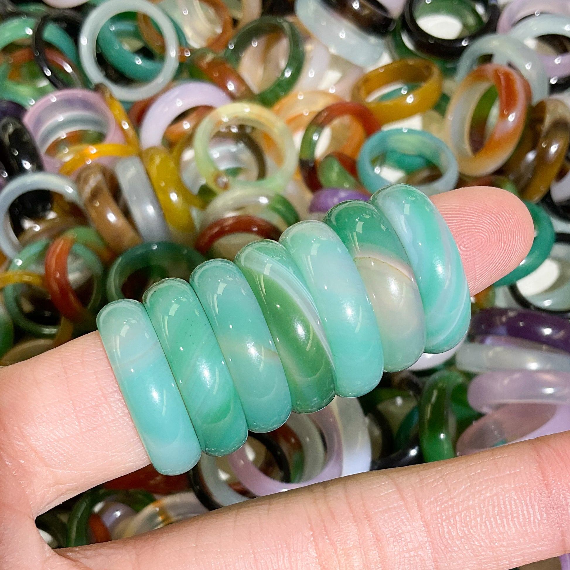 stacked banded green agate rings modeled on finger