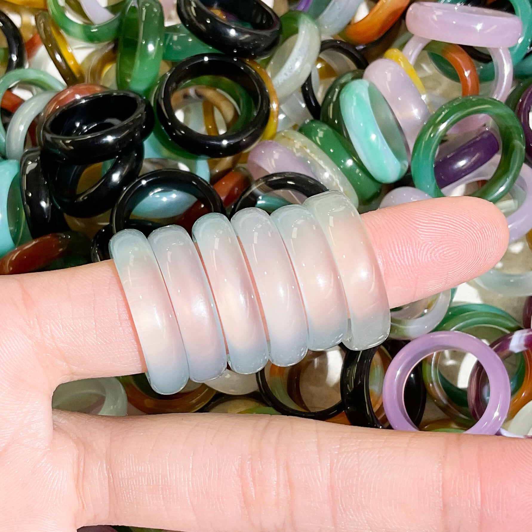 translucent clear blue agate rings modeled on finger