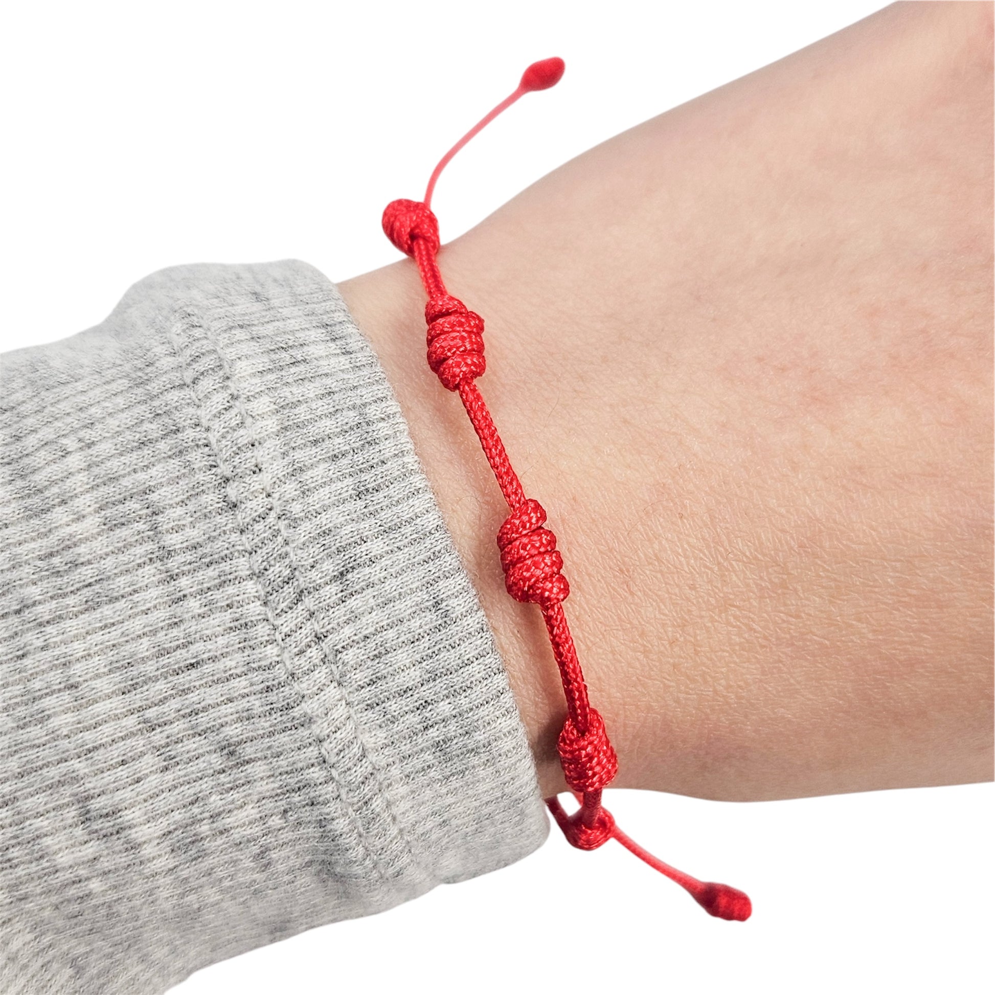 Red string adjustable bracelet with 7 knots modeled on wrist