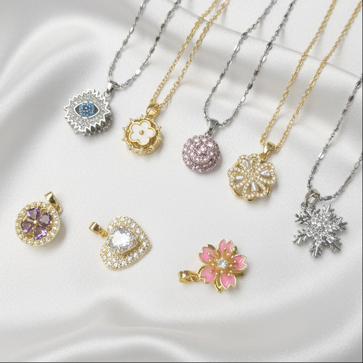 Collection of various necklaces with pendants on a white fabric background